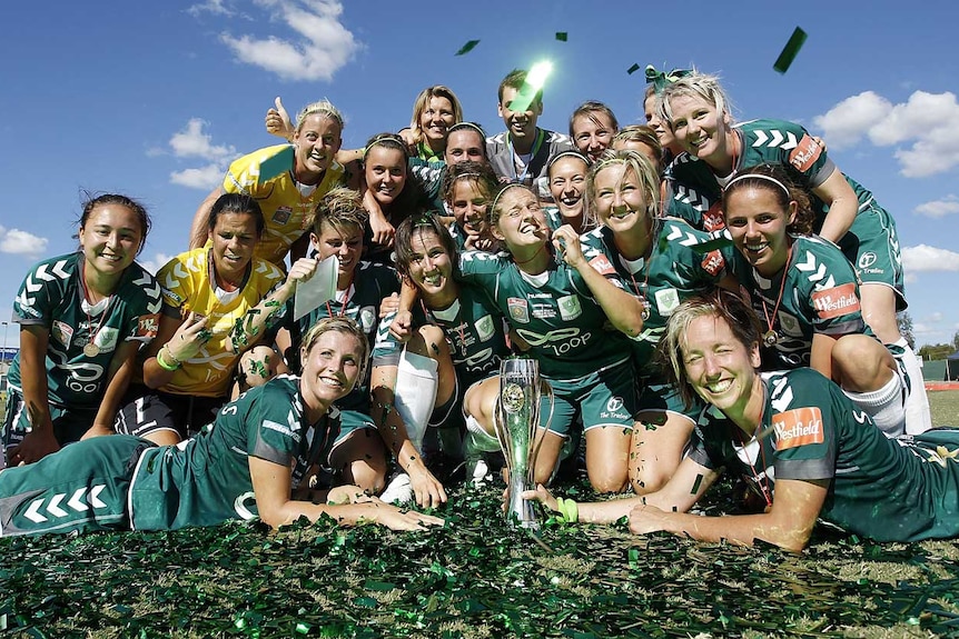 Canberra celebrates with the W-League trophy