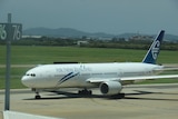 Air New Zealand jet in taxi along an airport runway