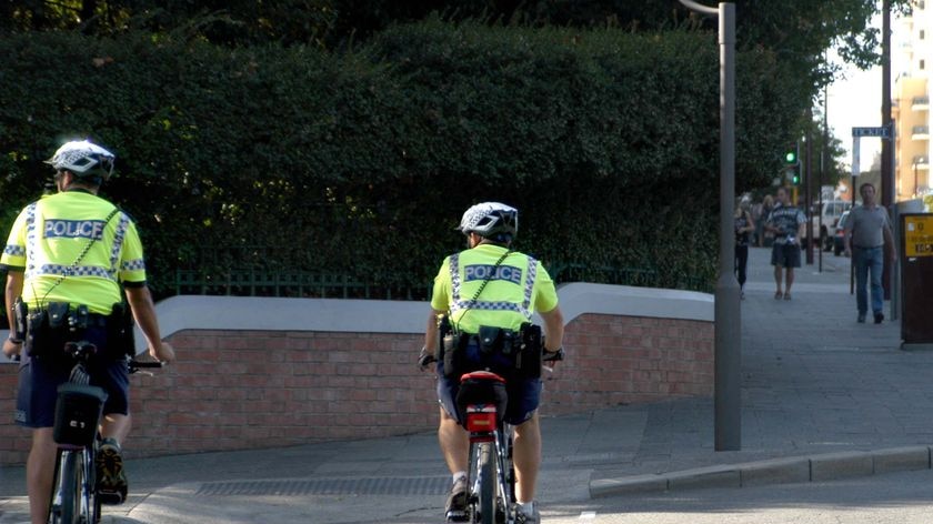 Two WA Police officers patrol the Perth CBD on bicycles