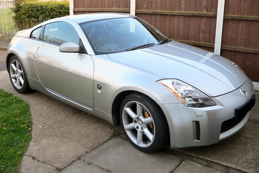 A  silver 2004 model Nissan 350z parked in a driveway