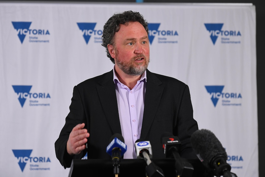 Professor Cowie addresses the media at a lectern