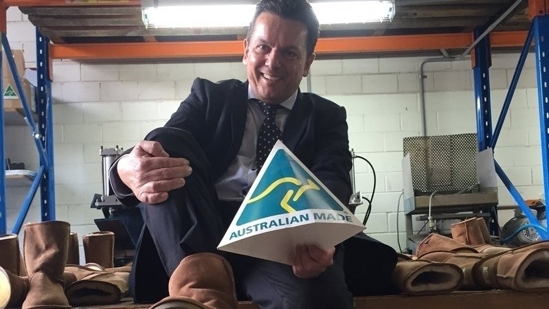 Nick Xenophon tries on ugg boots.