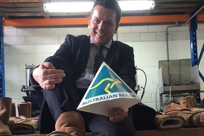 Nick Xenophon tries on ugg boots.
