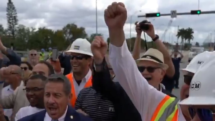 People celebrate the completion of the Florida bridge