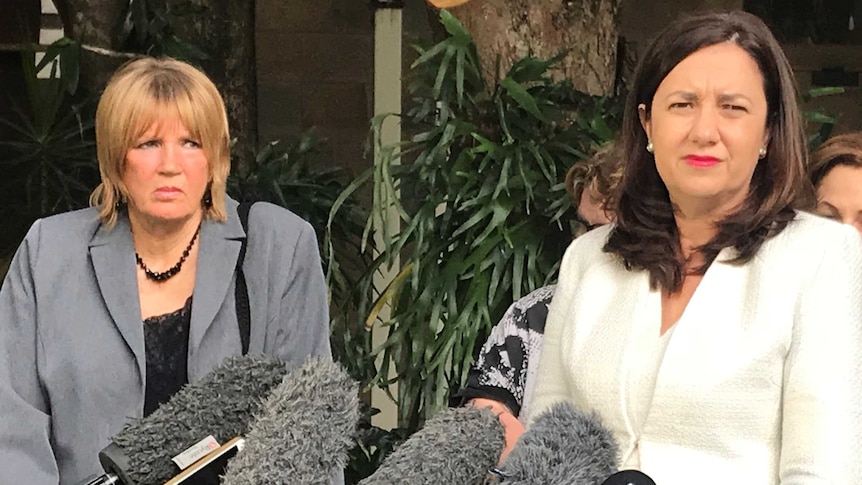 Mary Adams (left) stands behind Queensland Premier Annastacia Palaszczuk speaking to the media at Parliament House in Brisbane.