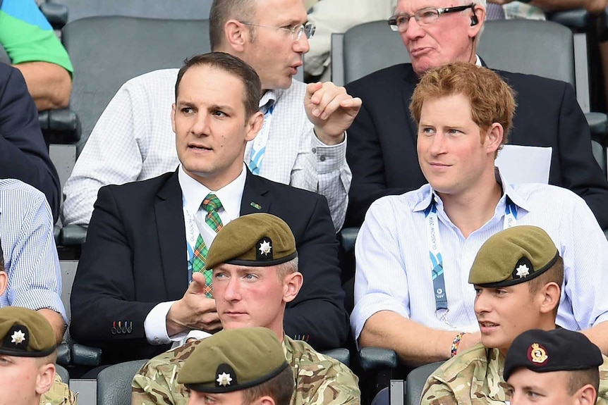 David Grevenmberg sits with Prince Harry at the 2014 Commonwealth Games in Glasgow