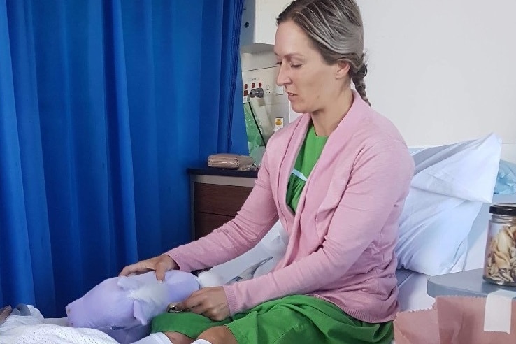 Skye Bogenhuber sits in a hospital bed