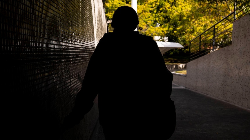 Teenage girl walking in tunnel