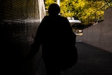 Teenage girl walking in tunnel