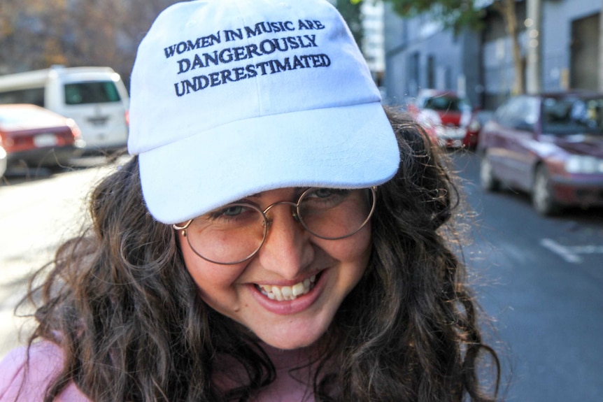 Close up of Hannah Donnelly's hat, which reads "women in music are dangerously underestimated"