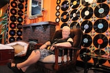 Linda Snook sitting in vintage arm chair of front bar at The Railway Hotel.