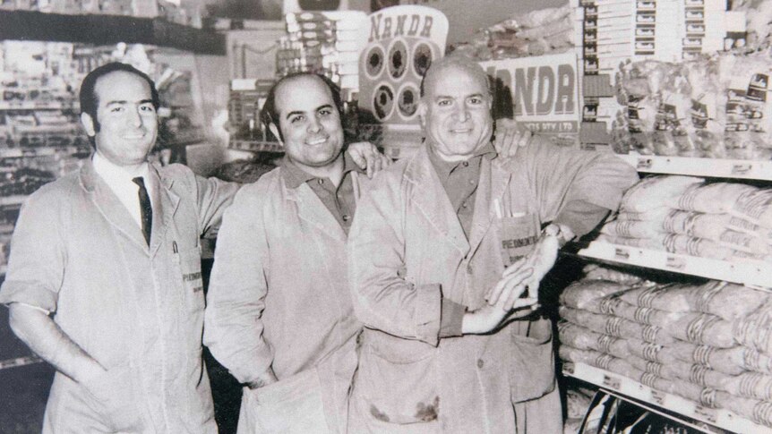 An early black and white photo of Giuseppe (right) and his two sons Salvatore and Carmelo in their store.