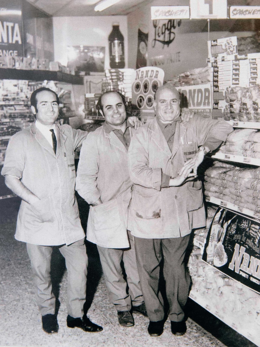 An early black and white photo of Giuseppe (right) and his two sons Salvatore and Carmelo in their store.