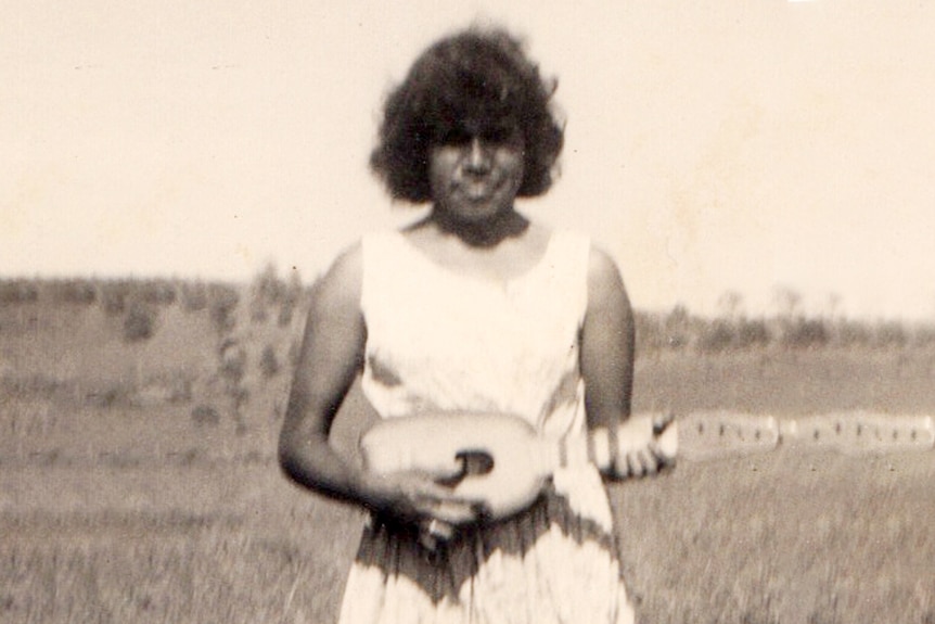 Portrait of an Indigenous teenager in the 1950s holding an ukulele