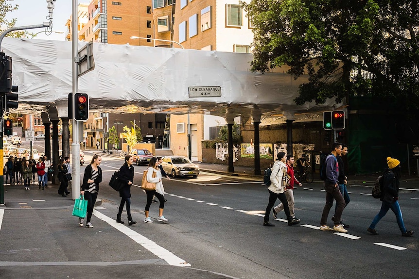 The Ultimo Road rail bridge under white plastic wrap