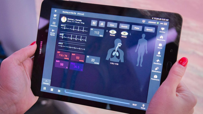 An i-Pad with health vitals listed.