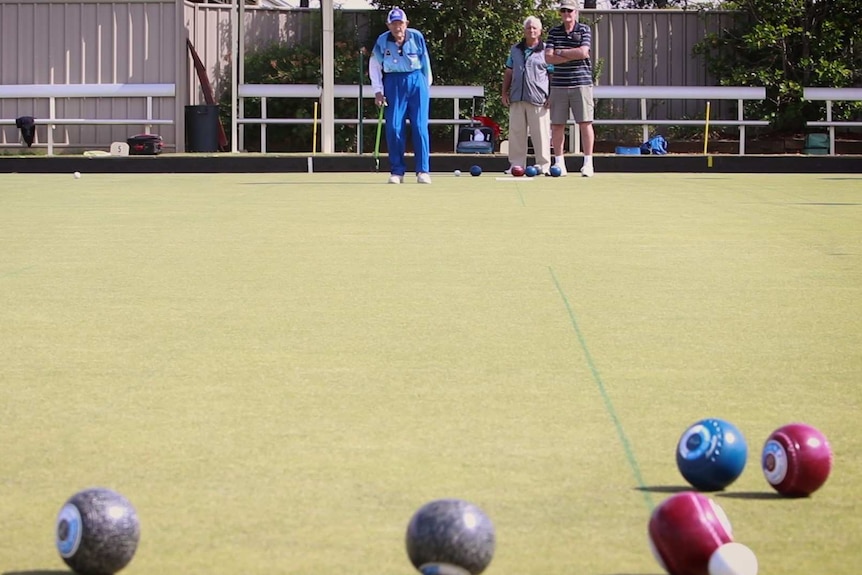 Long shot of players on a bowling gren