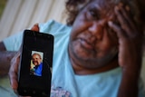 Louise Rankine holds a photo of her daughter Kwementyaye Green, who was found dead in Tennant Creek in 2013.