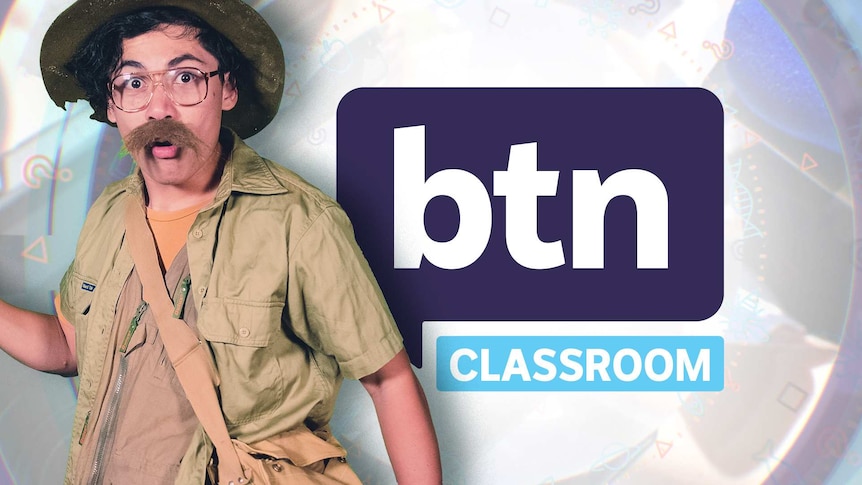 Nat dressed like an explorer stands in front of the BTN logo.