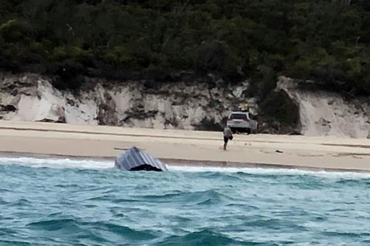 Overturned boat stuck fast in sand at beach on the western side of Fraser Island.