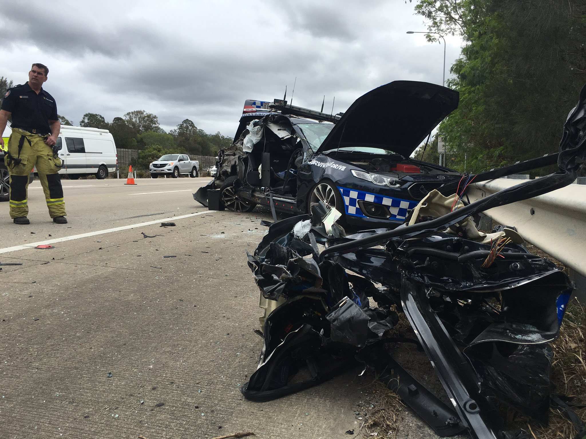 Queensland police officer injured as truck crashes into patrol car on
