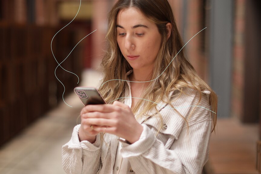 Lauren looks at her phone in her hands. It has an illustrated outline and illustrated wavy lines come towards her from the phone