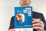 A man holds up a brochure saying: "A simple bowel test could save your life."