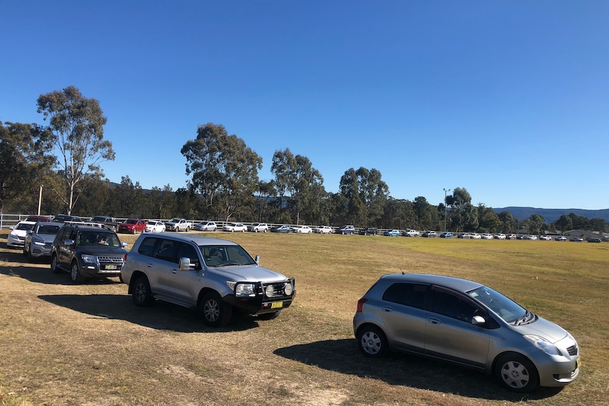 An endless line of cars wraps around a showground 