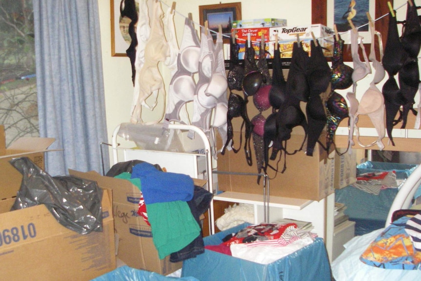 A spare bedroom filled with pre-loved clothes