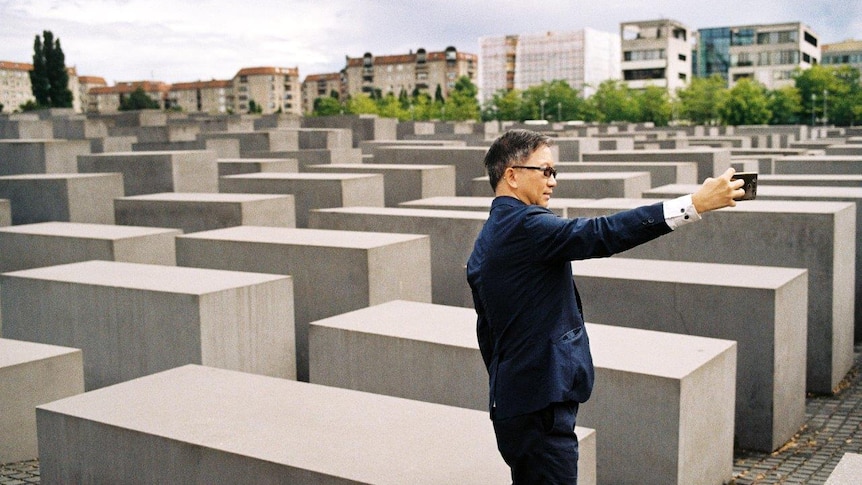 A tourists grab a selfie at the Memorial to the Murdered Jews of Europe.