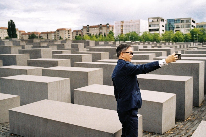 A tourists grab a selfie at the Memorial to the Murdered Jews of Europe.