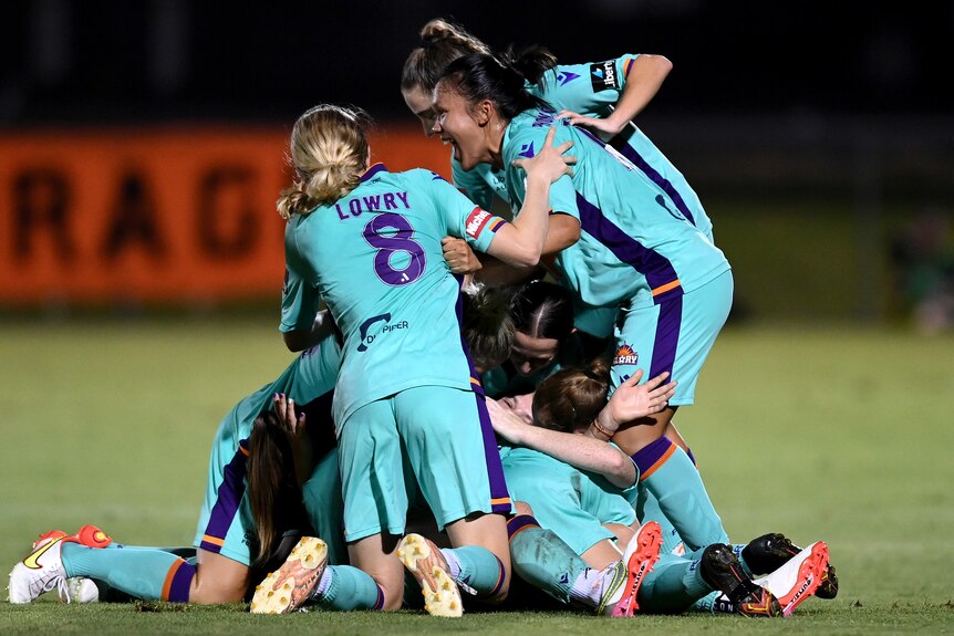 Perth Glory's Alana Jancevski celebrates with her teammates after scoring a goal against Brisbane Roar 
