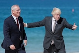 Boris Johnson gestures to Scott Morrison.