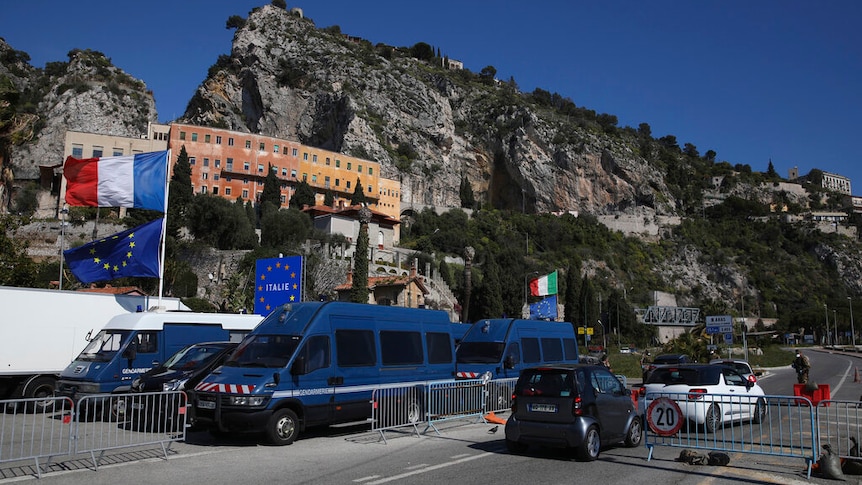 You're looking at a makeshift road block set against a dramatic mountaintop on a clear day.