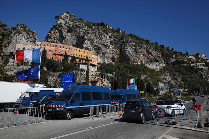 You're looking at a makeshift road block set against a dramatic mountaintop on a clear day.