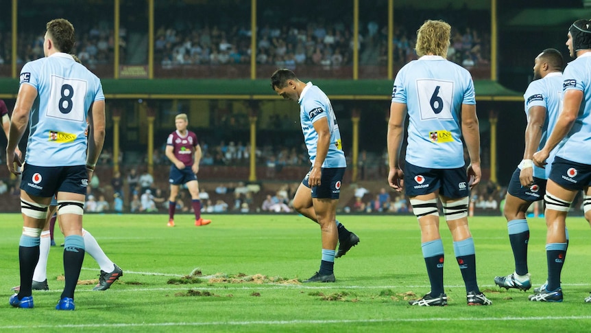 The NSW Waratahs players stamp on the rutted ground at the SCG