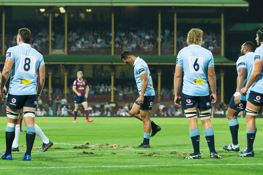 The NSW Waratahs players stamp on the rutted ground at the SCG