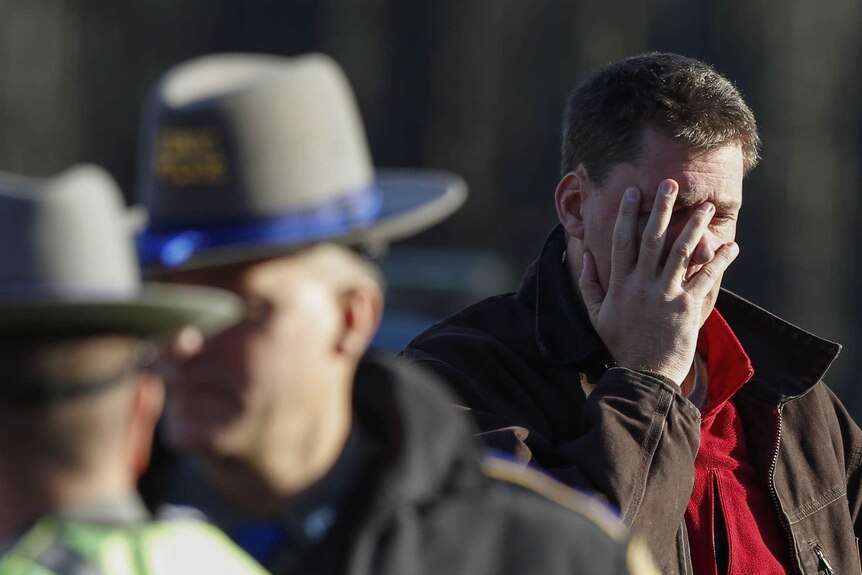 Man grieves at scene of school shooting