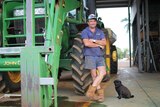a  man and a dog next to a tractor