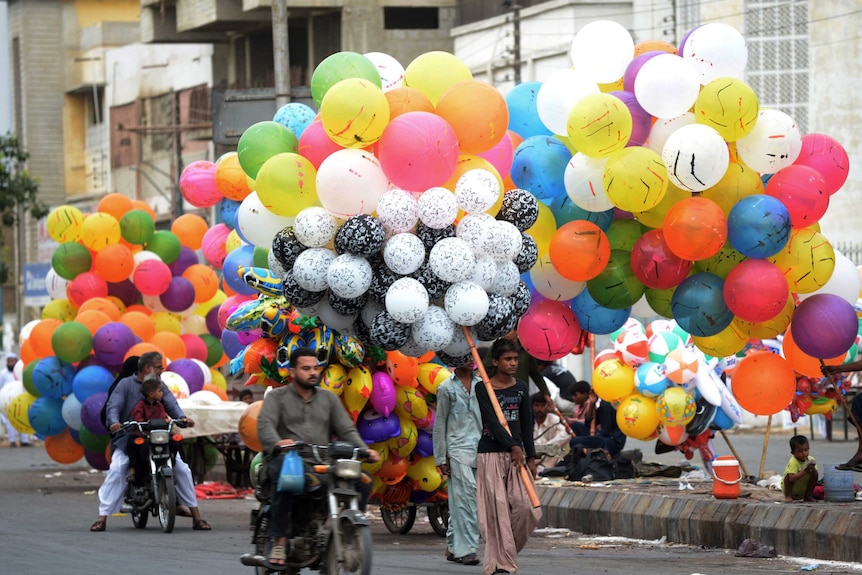 Pakistani vendors sell balloons to mark the start of Eid ul Fitr