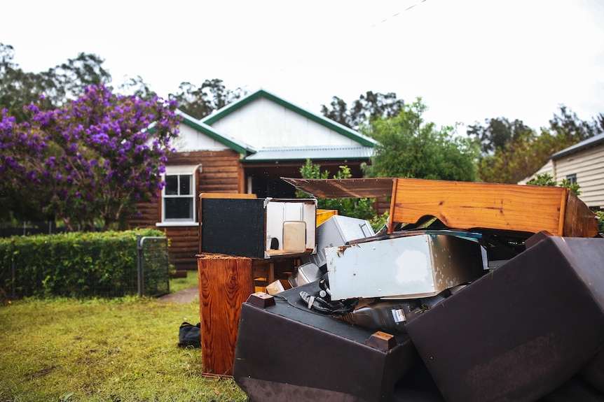 A pile of debris in front of a house.