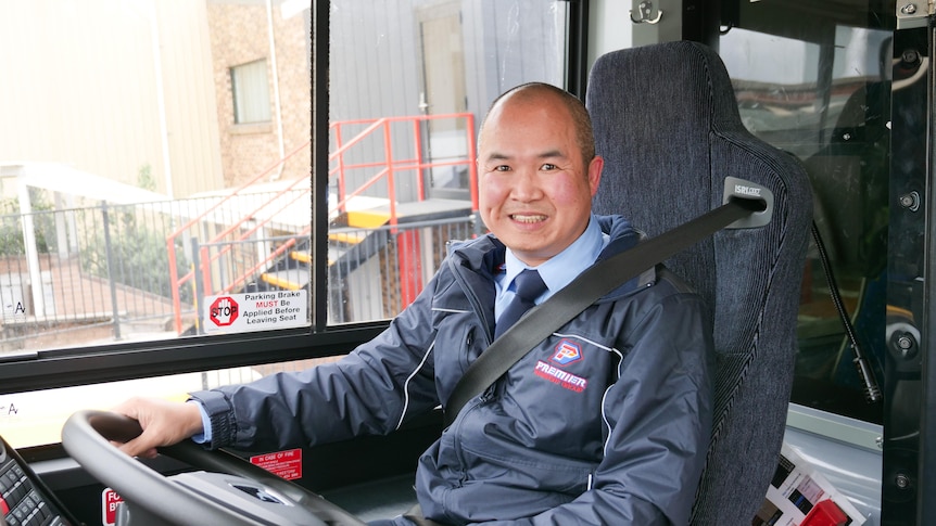 Leo Pham behind the steering wheel of his bus 