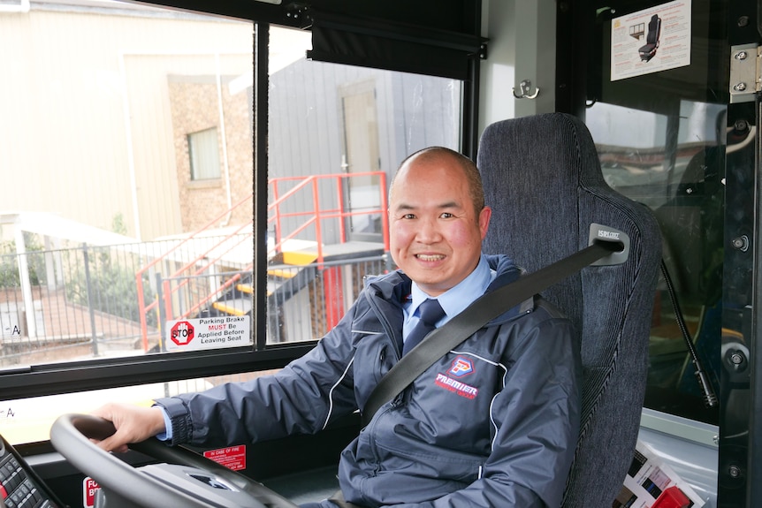Leo Pham behind the steering wheel of his bus 