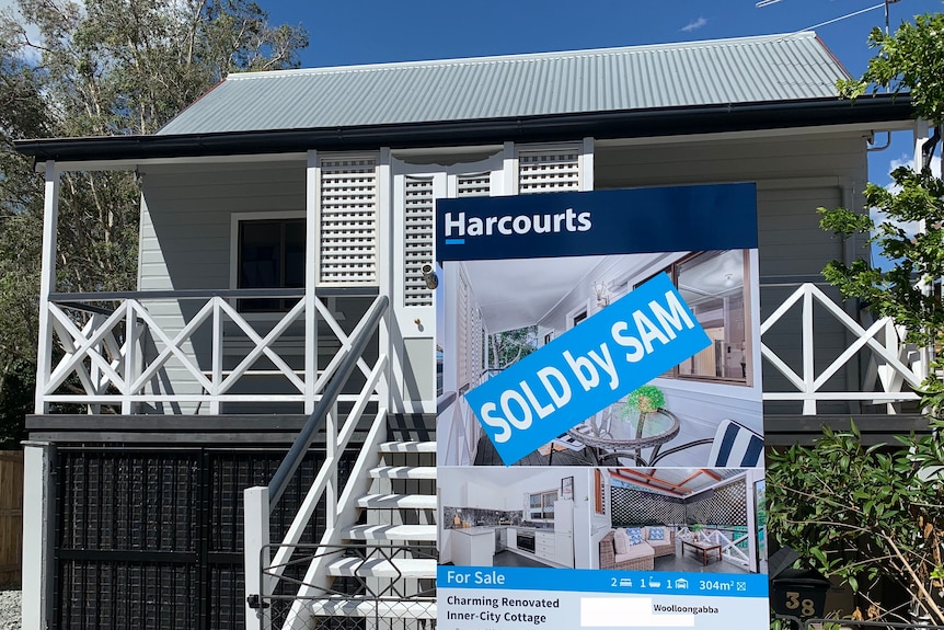 Renovated wooden cottage with Sold sign in Brisbane