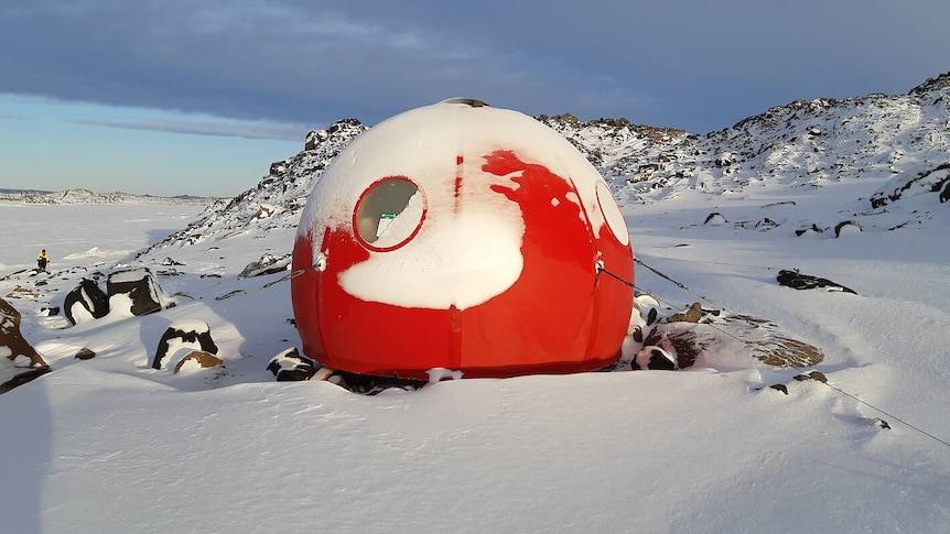Bright red dome sits in snowy Antarctic landscape