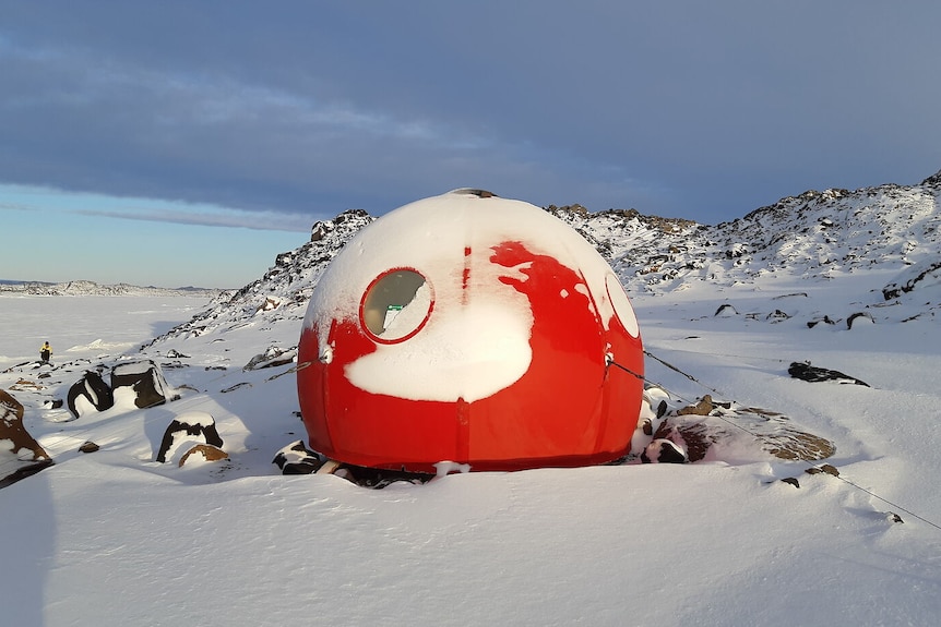 Bright red dome sits in snowy Antarctic landscape