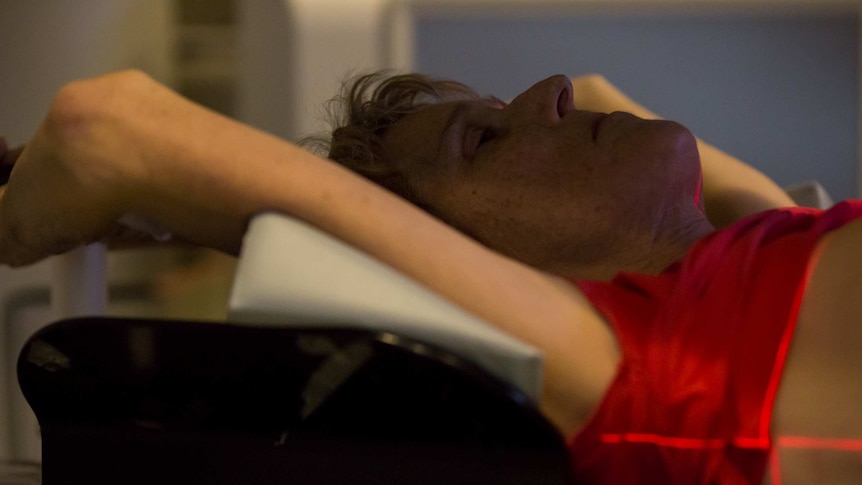 Sue Jensen lies back during radiotherapy treatment.