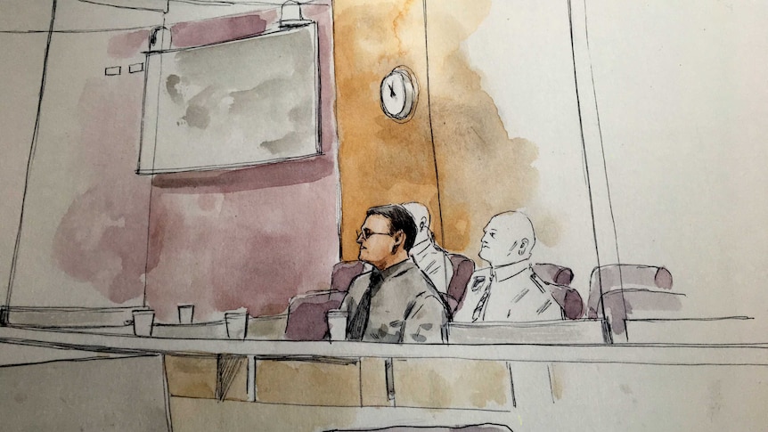 Sketch of a bespectacled man sitting in the dock of a court with two guards behind him.