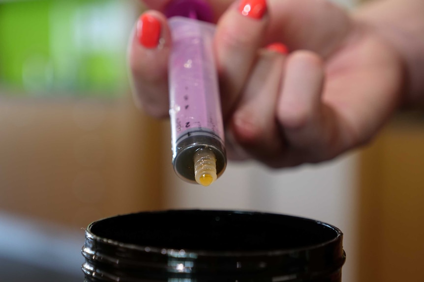 A closeup of a syringe and a honey jar at Perth Children's Hospital in August 2020.