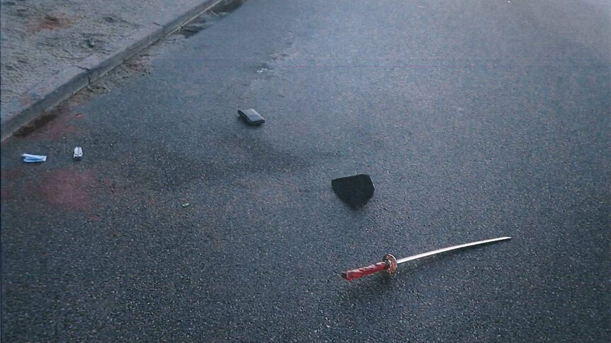 A samurai sword on a suburban bitumen road.